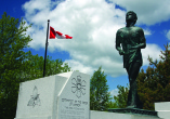 terry fox monument with canadian flag and cloudy sky behind