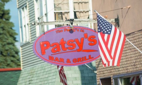 purple and red oval sign for patsy's bar & grill