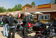 group of riders with motorcycles in front of restaurant